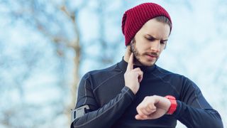 A runner checks his heart rate