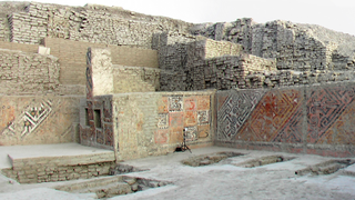 Stacked brick walls and a lower course of painted brick surround burials at the Huaca Cao Viejo temple at the El Brujo archaeological complex in Peru.