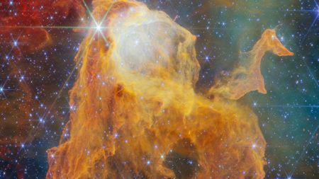 Orange gas floats in deep space.