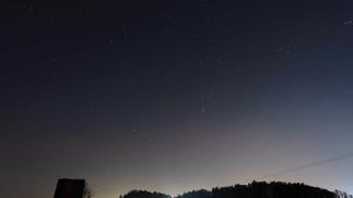 Night sky image of stars above silhouetted horizon