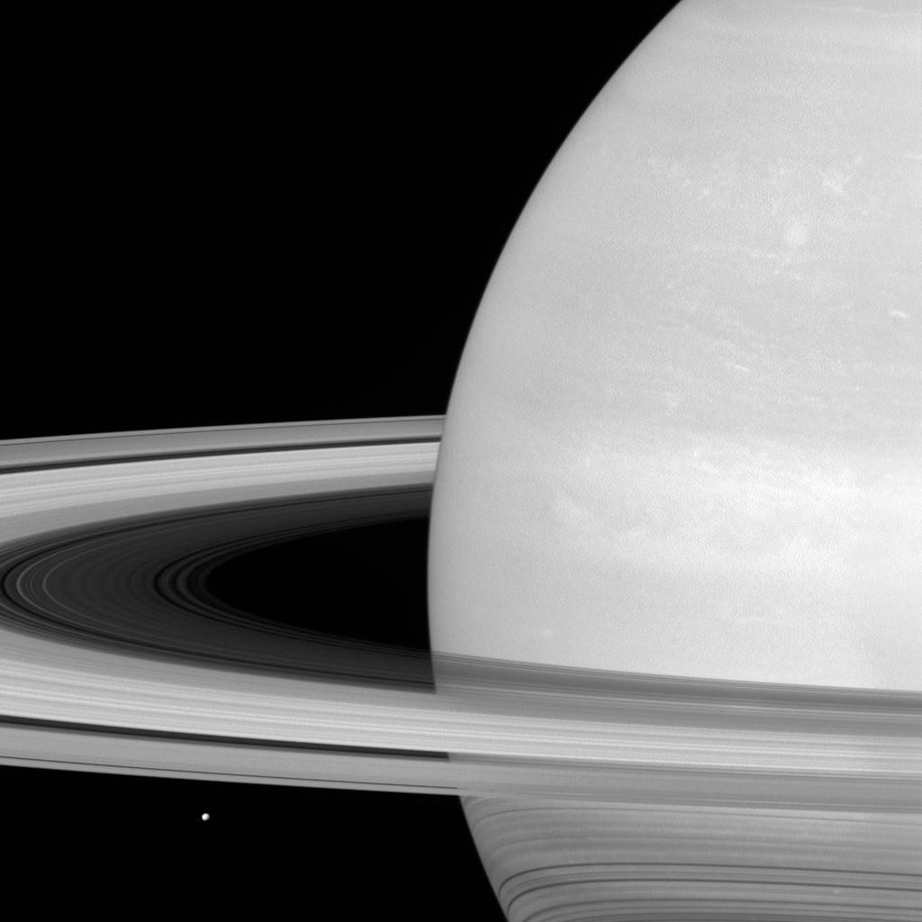 Saturn&amp;#039;s moon Mimas is spotted near its rings.