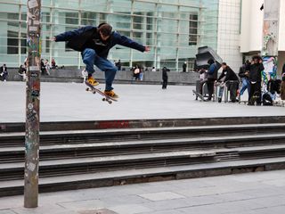 Person skateboarding down stone steps in Barcelona