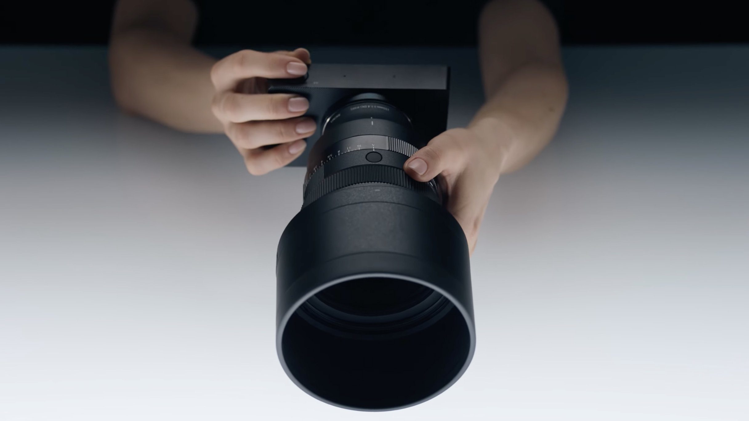 Sigma 135mm f/1.4 DG Art lens on a Sigma BF body in a photographer&#039;s hands