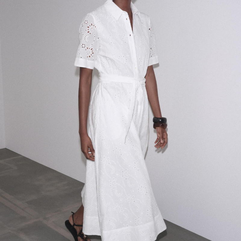 A model wearing a white shirt dress
