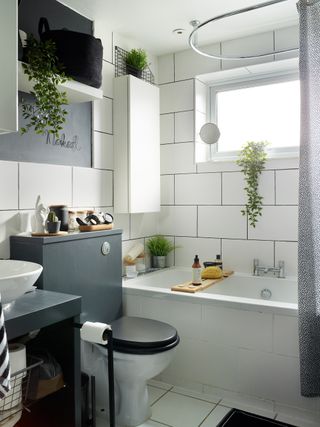 Monochrome bathroom with white wall tiles and grey furniture