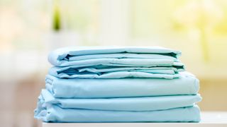 A pile of blue bedding sheets
