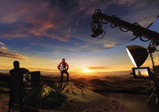 Man overlooking the sunset over mountains while being filmed with Samsung equipment