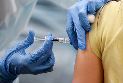 A woman receives a flu vaccine.