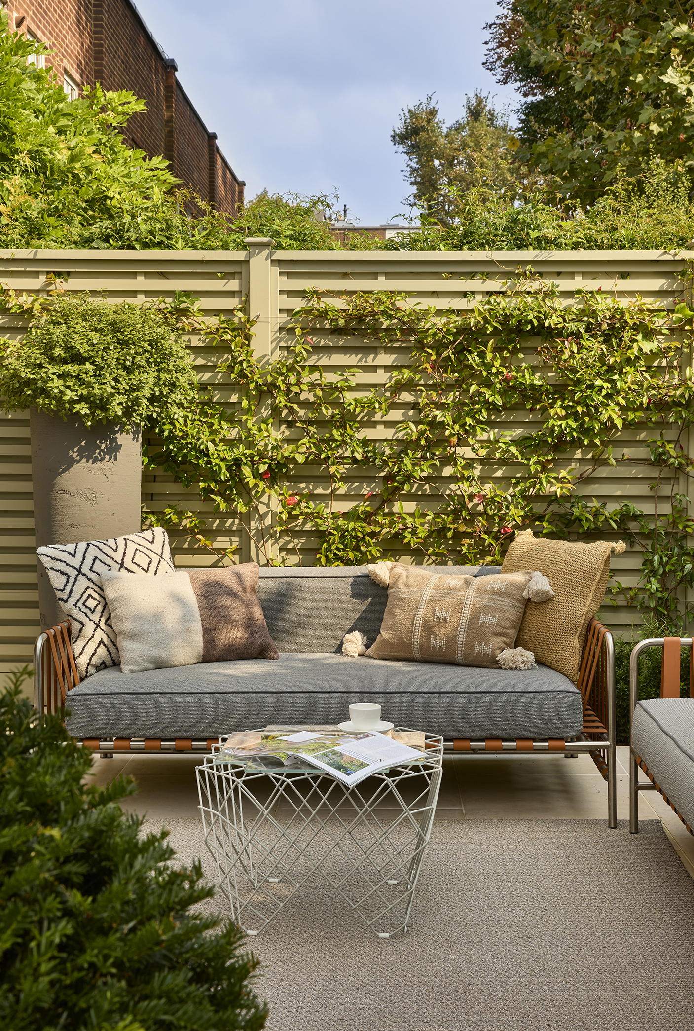 Gandia Blasco outdoor sofa with woven cushions, wire coffee table and outdoor rug