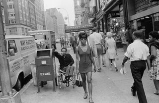 People walk along a New York street