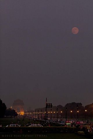 "Yesterday's blue moon was actually reddish when it rose over the Avenue Rajpath, New Delhi," wrote photographer Ajay Talwar. "Actually it was lucky to have been visible at all during the Indian Monsoons."