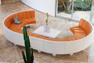 orange and white curved sofa around low table