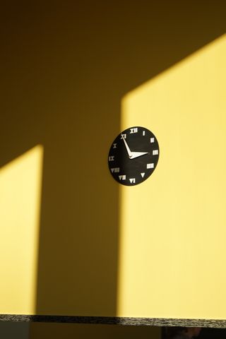 clock on yellow wall