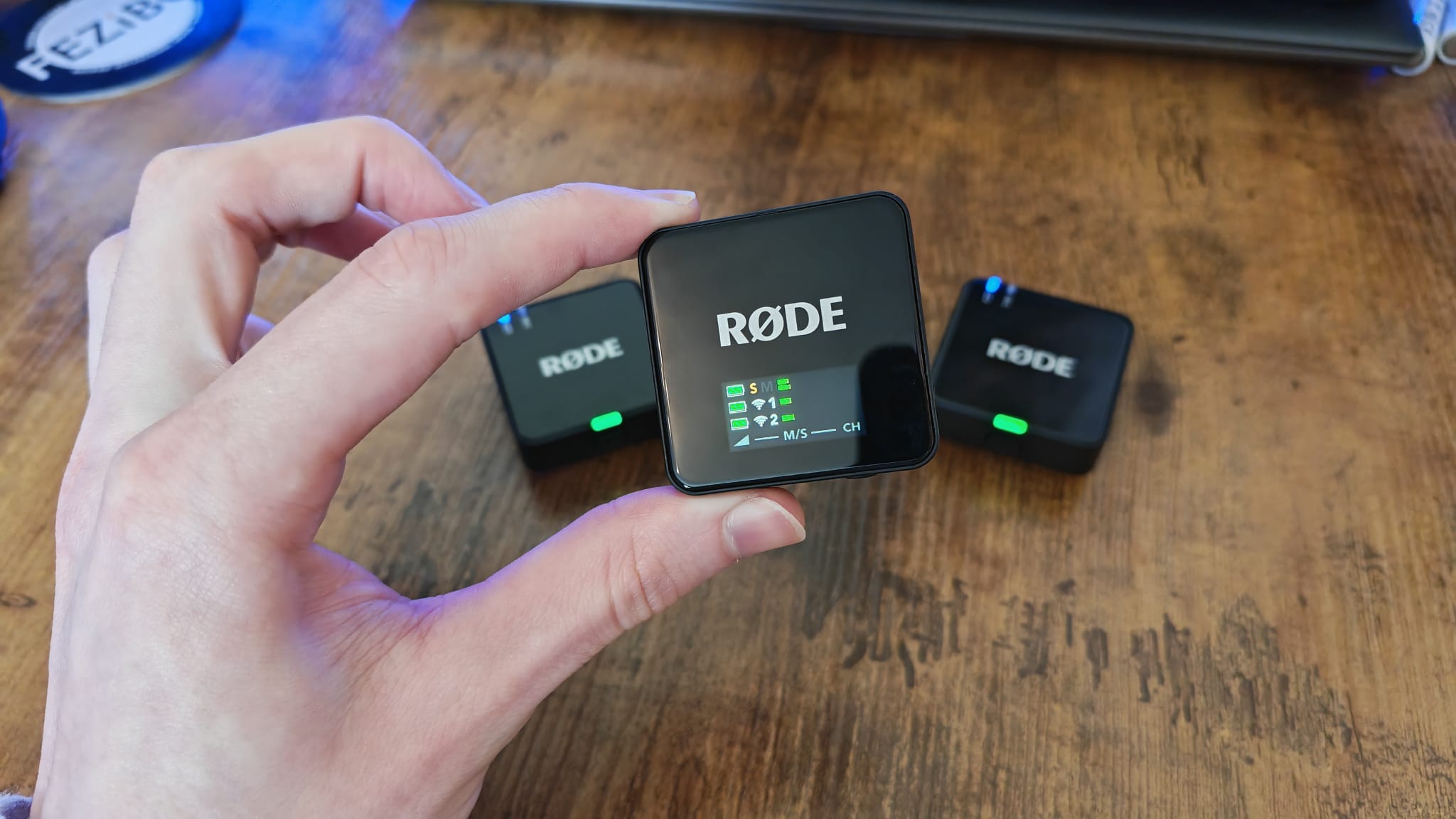 The Rode Wireless Go Gen 3 receiver held above the two transmitters