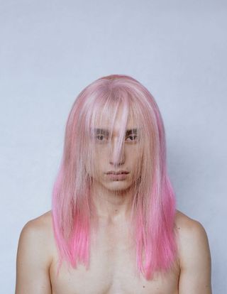 man in wig with long pink straight hair