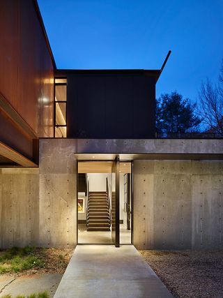 A simple concrete entrance leads to the building’s main staircase that leads to the top