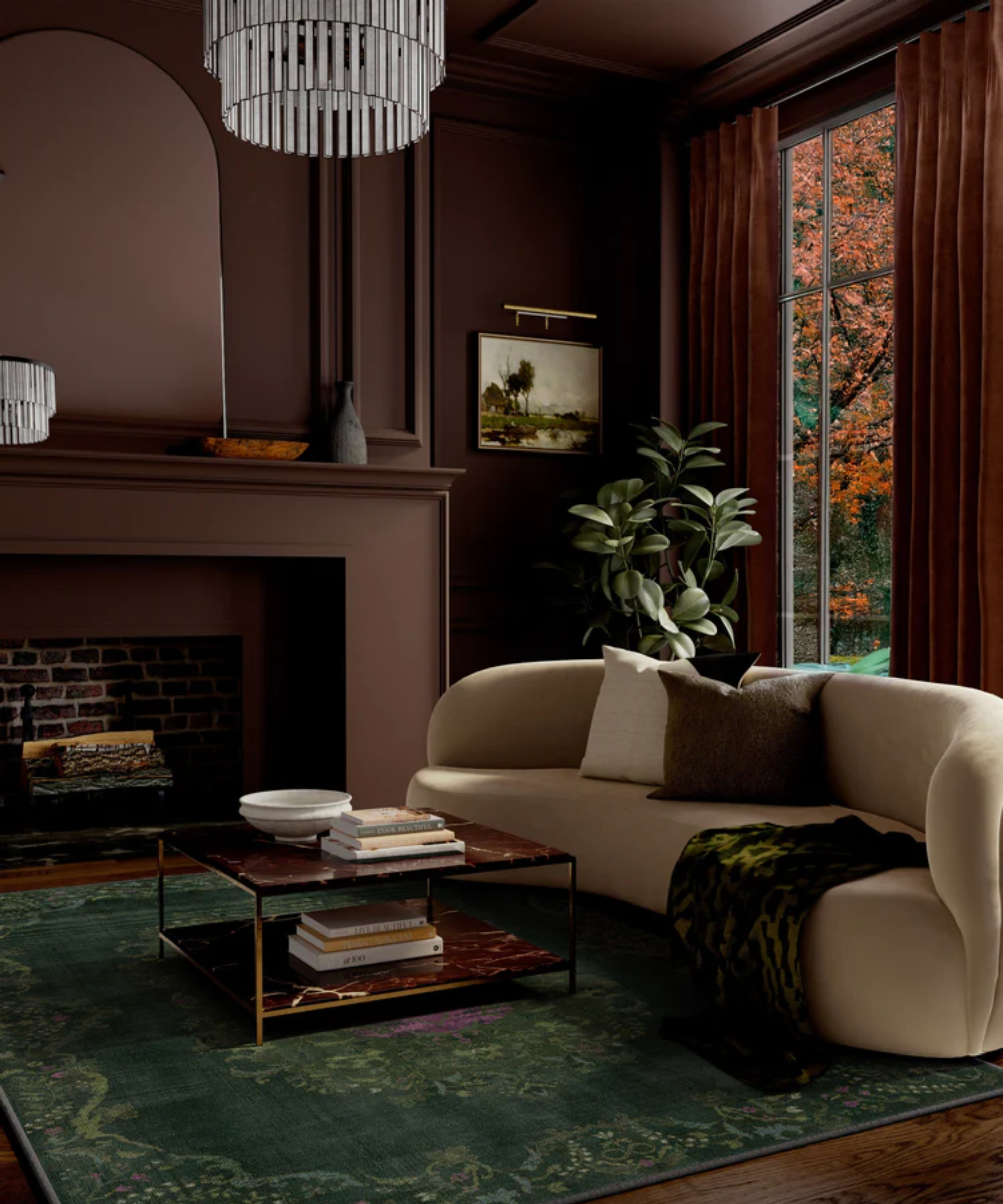 a dark living room with a tan couch, a coffee table with books on top, and a green rug