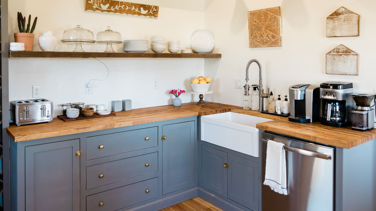 Kitchen with blue cabinets and wooden countertops