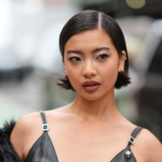 A woman at fashion week with strong eyebrows illustrating a guide to the best brow pens of 2024