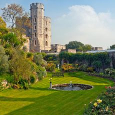 gardens at Windsor Castle with orange roses, benches and water feature