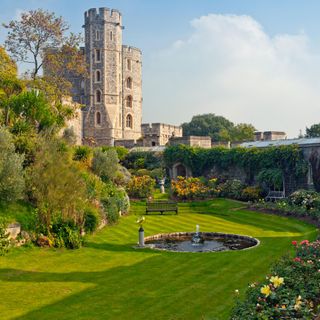 gardens at Windsor Castle with orange roses, benches and water feature