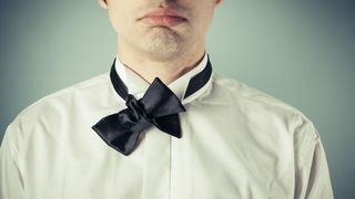 How to tie a bowtie - tuck longer end through loop behind shorter end