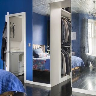 blue bedroom with mirrored wardrobes