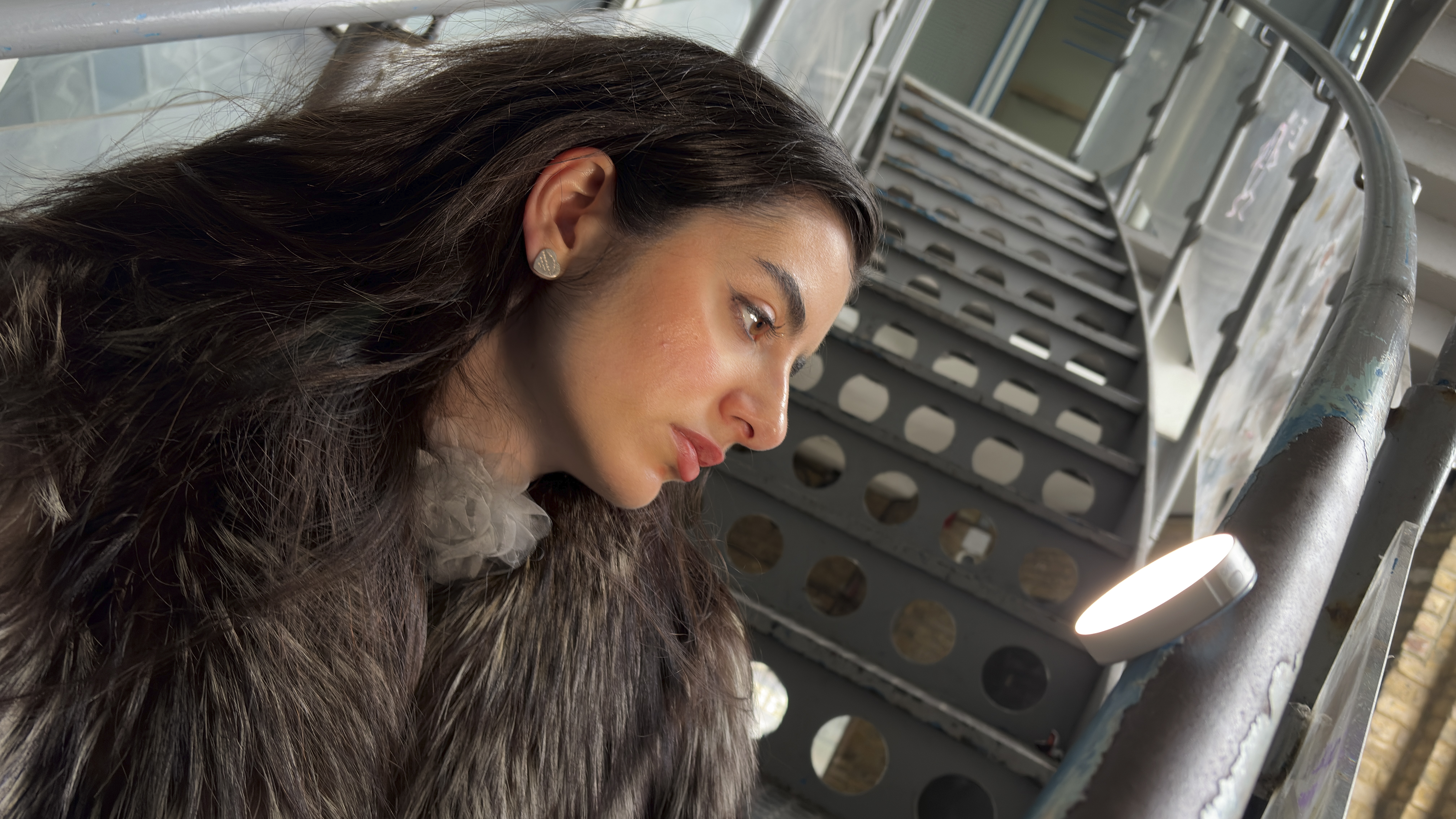 A shot of a model looking towards the smaller LR15Bi LED which is magnetically attached to a rail. It adds a little catch light to her eye and rim light to her nose.