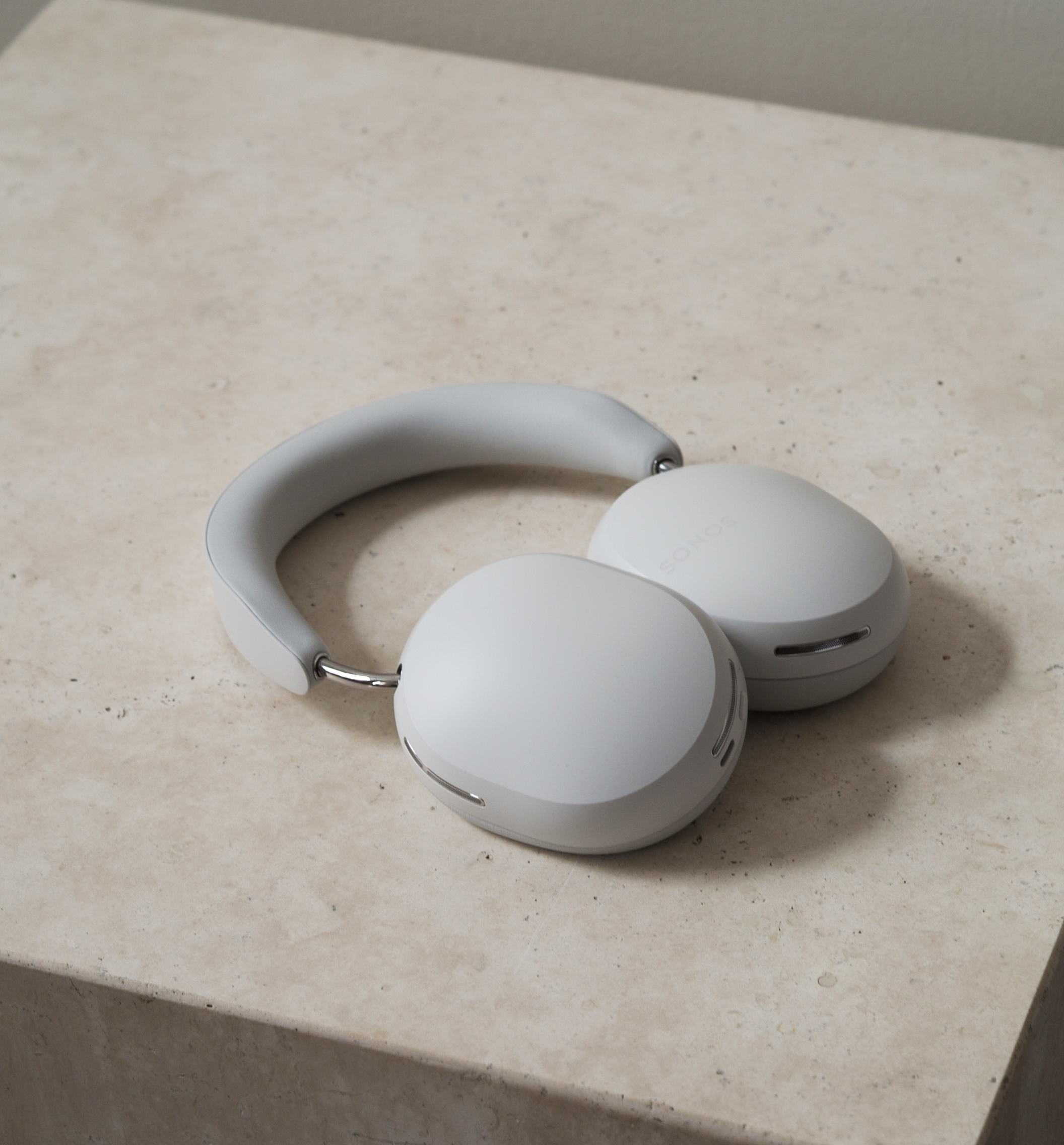 sonos ace headphones on a stone table