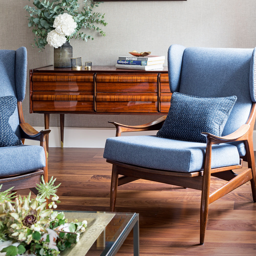 living area with wooden flooring and wooden chair with cushions