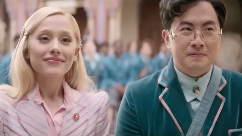 Ariana Grande and Bowen Yang in Wicked sitting next to each other.