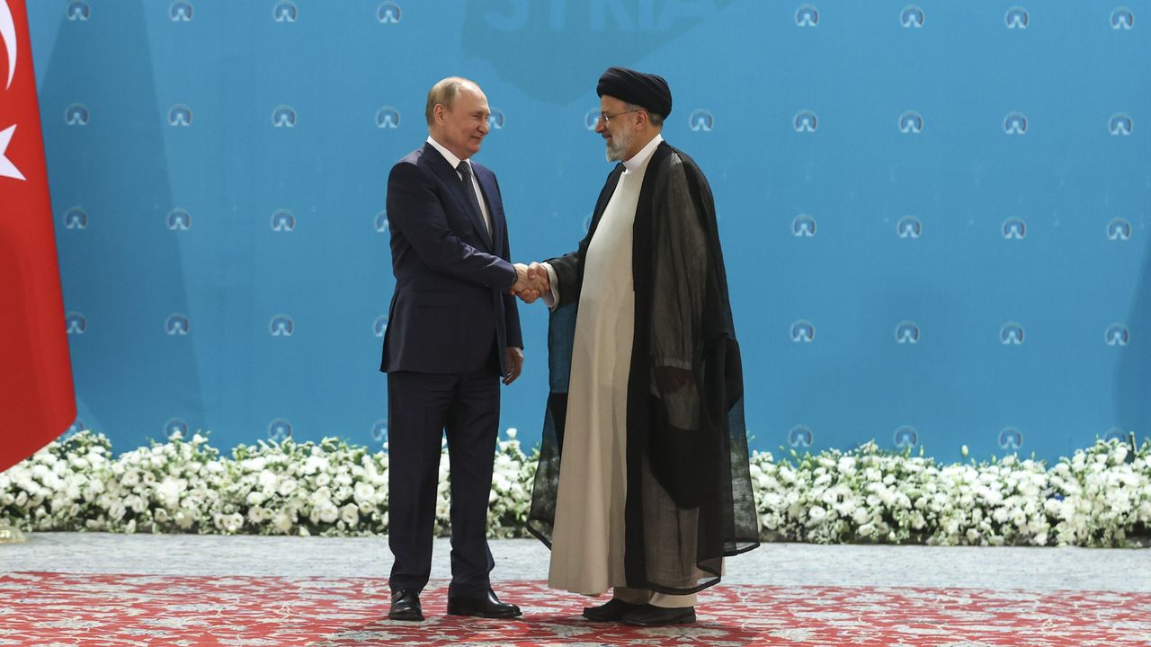 Russian President Vladimir Putin shakes hands with Iranian President Ebrahim Raisi ahead of talks in Tehran 