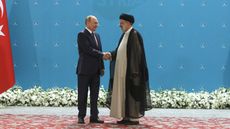 Russian President Vladimir Putin shakes hands with Iranian President Ebrahim Raisi ahead of talks in Tehran 