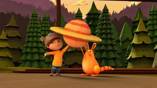 Since Pluto is considered a dwarf planet rather than a regular planet, Mindy (pictured here with Jet's pet Sunspot) choses to reconstruct Saturn for her papier-mâché school project in a new episode of the PBS KIDS show "Ready Jet Go!"