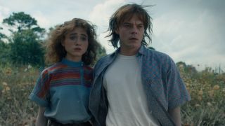 Natalia Dyer as Nancy and Charlie Heaton as Jonathan looking at Hawkins in Stranger Things' Season 4 finale