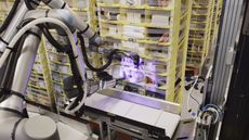 Amazon's Vulcan robot picks up items from storage pods.