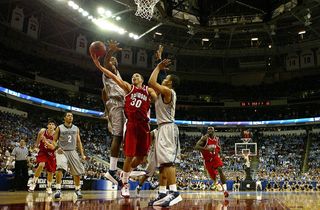  Stephen Curry #30 of the Davidson Wildcats goes up for a basket between teammates DeJuan Summers #3 and Chris Wright #4 of the Georgetown Hoyas during the second round of the 2008 NCAA Men's Basketball Tournament Midwest Regionals on March 23, 2008 at RB