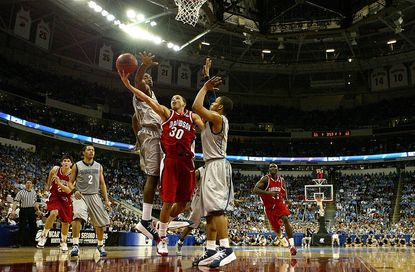  Stephen Curry #30 of the Davidson Wildcats goes up for a basket between teammates DeJuan Summers #3 and Chris Wright #4 of the Georgetown Hoyas during the second round of the 2008 NCAA Men's Basketball Tournament Midwest Regionals on March 23, 2008 at RB