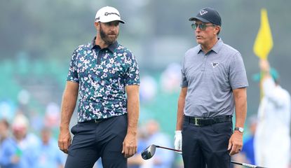 Dustin Johnson and Phil Mickelson chat during the Masters