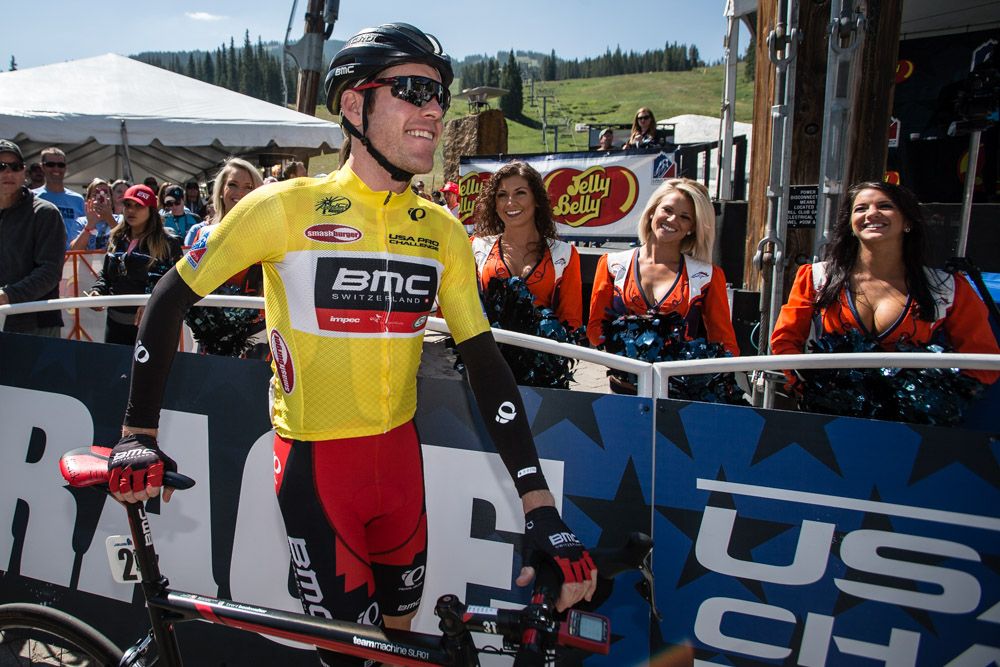 Brent Bookwalter (BMC) gets welcomed to the start line by several Denver Broncos cheerleaders