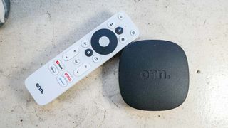 (R, L) The onn 4K Google TV streaming box and remote