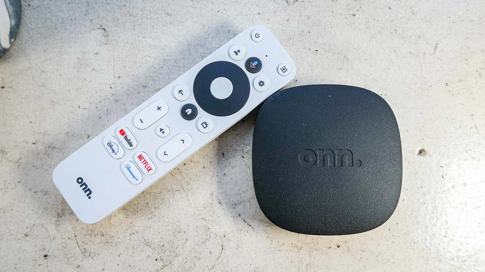 (R, L) Google TV streaming box and remote control