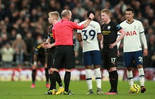 Manchester City’s Oleksandr Zinchenko, left, is shown a red card