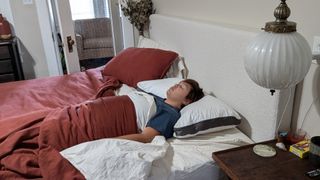 Reviewer Alex sleeping on the Sleep Number NaturalFit Ultimate Pillow