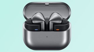 Leaked images of the Samsung Galaxy Buds 3 charging case. The case is black and the earbuds are black. Teal background