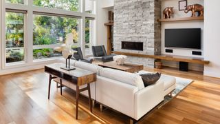 How to add value to your home: An image of a living room interior with hardwood floors and fireplace in new luxury home