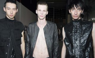 Male models wearing dark shades from the collection