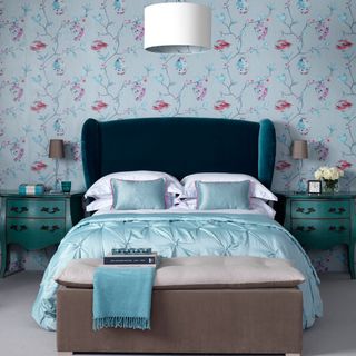bedroom with wallpaper and side table