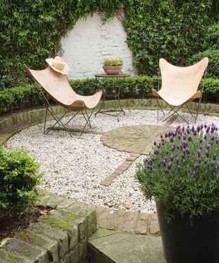 stony garden seating area with lavender plant in the foreground