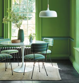 a dining room painted in vivid green